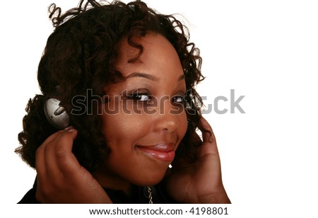 isolated african american girl show very happy expression wearing headset to listen to music while looking at the camera