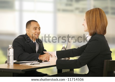 two business people shaking hand over table. focus on the woman. concept for business deal, team work, selling or agreement