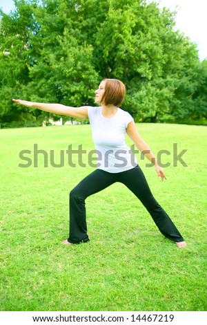 pretty young woman doing yoga outdoor in a park. concept for yoga or wellbeing