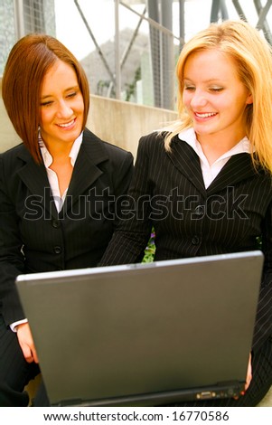 two business women looking at laptop with happy expression. concept for business