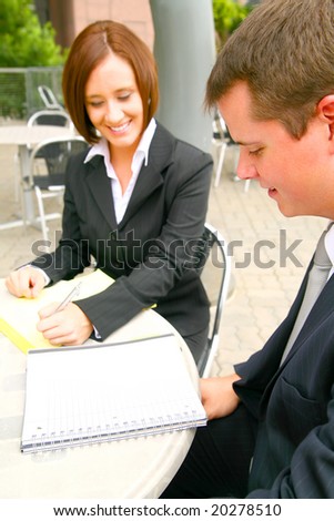 business man reviewing paper work from his team mate