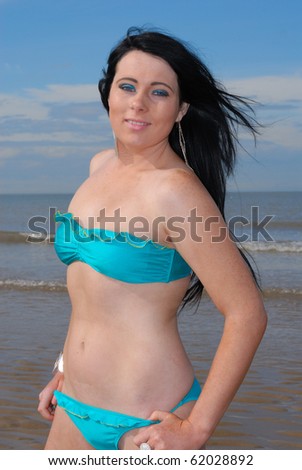 Cute young woman in bikini at beach