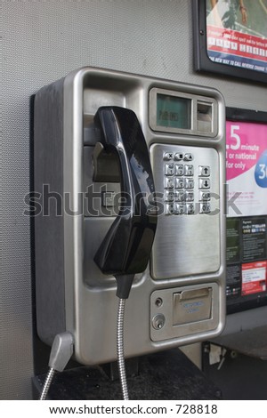 Metal telephone booth with push buttons and black handset