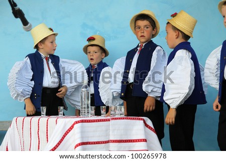 SIC, ROMANIA -AUGUST 24, 2011: unidentified Children between the age of 6-10 are performing in traditional clothes at the Sic Village Festival Days, at August 24, 2011, in Sic (Szek), Romania