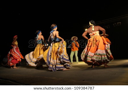 ASSEMINI, SARDINIA - AUGUST 1: A folklore dancing group from Columbia, performs during the International Folk Festival Is Pariglias 2012, on August 1, 2012 in Assemini, Sardinia.