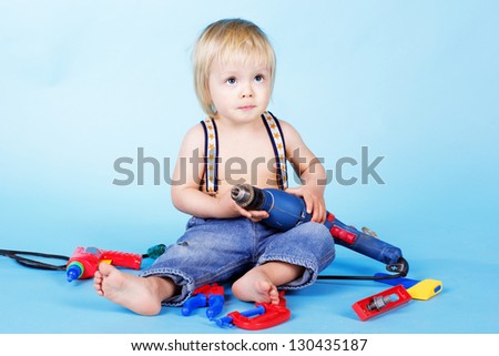 Little baby boy play with build tools