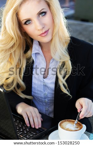 Young pretty business blonde woman with notebook