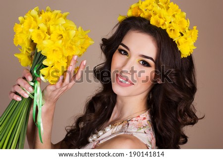 Happy smiling girl with yellow flowers