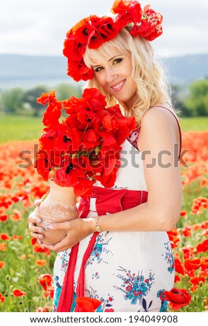 Beautiful blonde girl with big bouquet of poppies