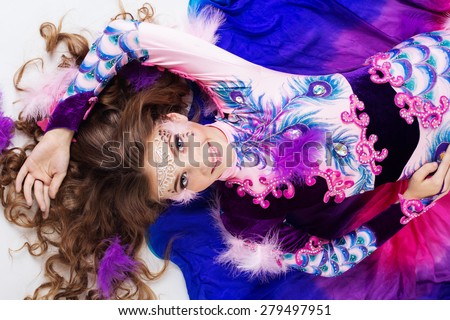 Beautiful belly dancer girl is wearing a colorful fashion costume.
