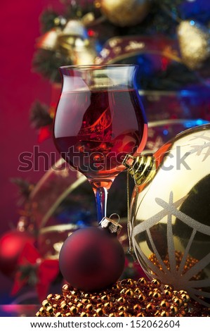 rose wine and Christmas decoration against color background