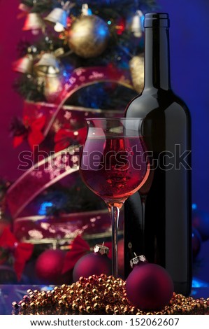 rose wine and Christmas decoration against color background