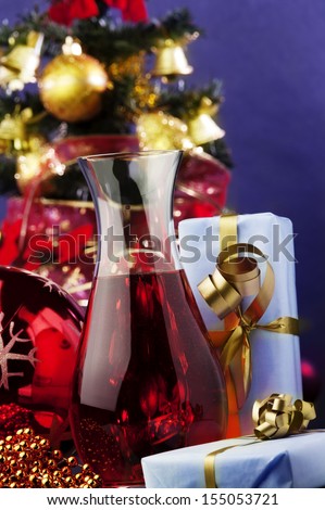 jug of rose wine and Christmas decoration against color background