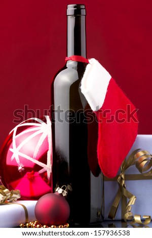 a bottle of red wine, gift boxes,red Christmas sock and Christmas decoration