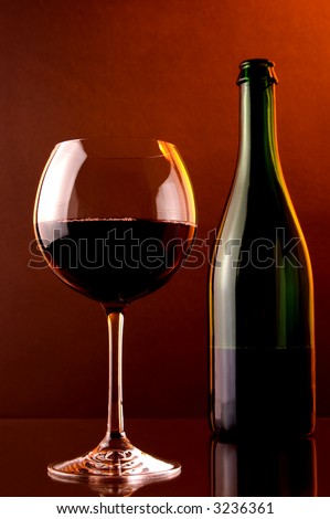 red  sparkling wine, glass and green bottle