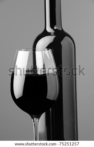 a glass of red wine and bottle of wine