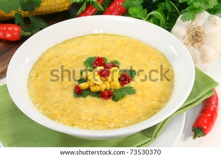 a cup of corn soup with chili and coriander