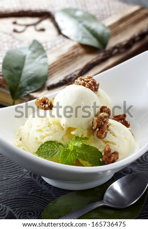 Scoop of walnut ice cream with caramel sauce