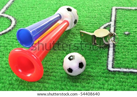 colorful soccer horn with football and whistle on a soccer field