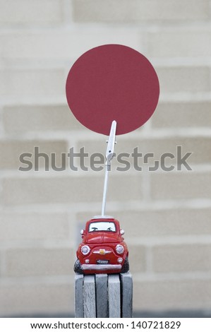 red car paper clip with a red circle to write custom text