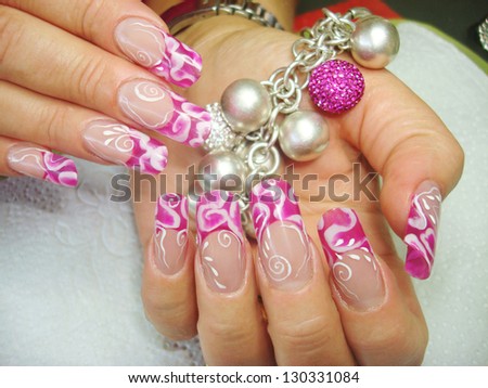 closeup of elegant see through pink abstract nail art design nails holding bracelet