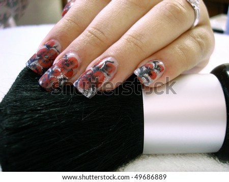 colored acrylic nail design and brush