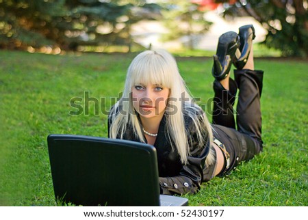 The girl with a  laptop on a nature