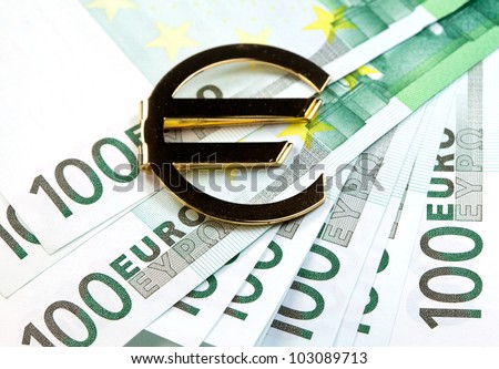 The money euro. Bundle of bank notes  and golden sign