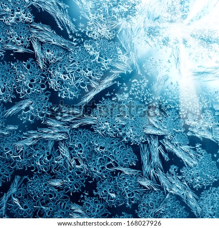 Frosty winter pattern at a window glass, macro texture
