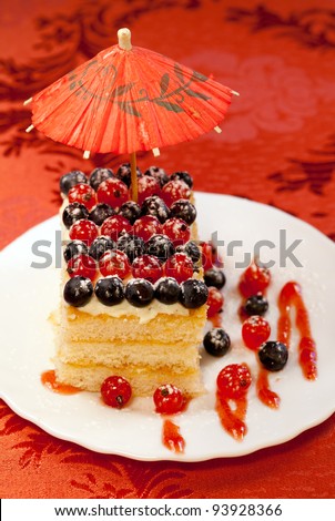 Tasty baked fancy cake decorated Red and black currant