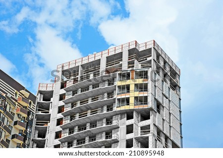 Building construction site wok with balcony against blue sky