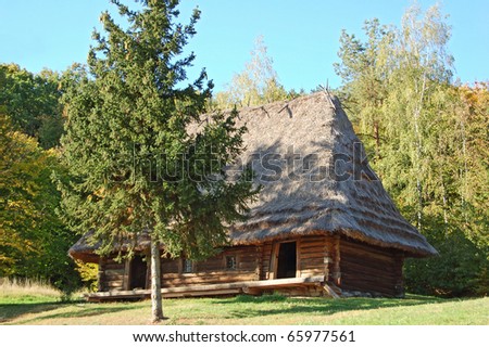 Ancient traditional ukrainian forest carpatian cottage with a straw roof