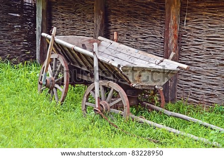 Ancient wooden cart standing on a green grass