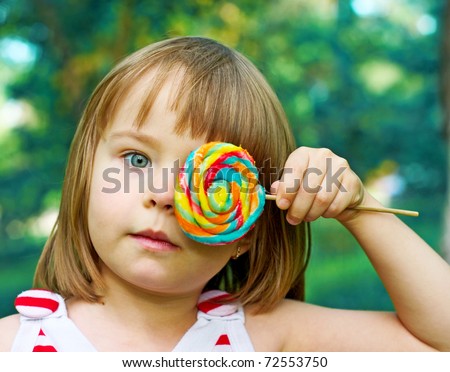 little girl closes eye candy