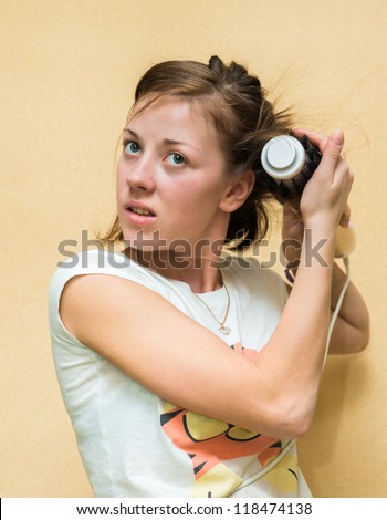 Brunette young girl dries hair dryer electric