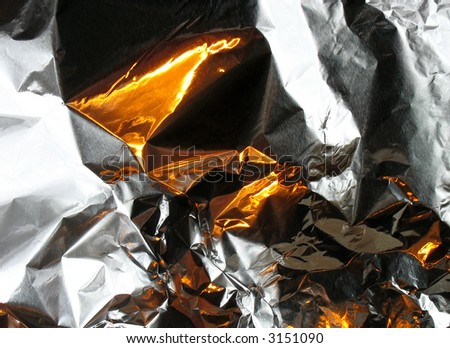 Patches of light of fire on metal.  Abstract background. Fantasy.