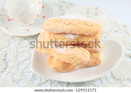 Cookies Ladyfingers, Savoiardi, sweet sponge cakes and coffee cup