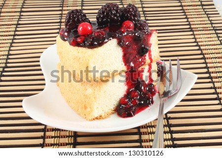 Slices of Angel Cake  topping with berry sauce