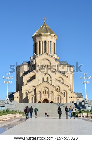 Tbilisi, Georgia - October 7, 2013: believers and tourists go to the Holy Trinity Cathedral of Tbilisi (Tsminda Sameba) - one of the largest Orthodox churches in the world.