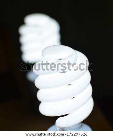 Energy saving bulbs, smart spiral light lamp on a dark background
