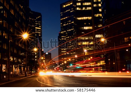 Long exposure shot of a busy street at night creating dynamic effect of the vehicle lights. photo taken Toronto Canada