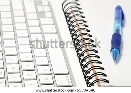 Keyboard and sketchbook or notepad concept, with a ballpoint pen