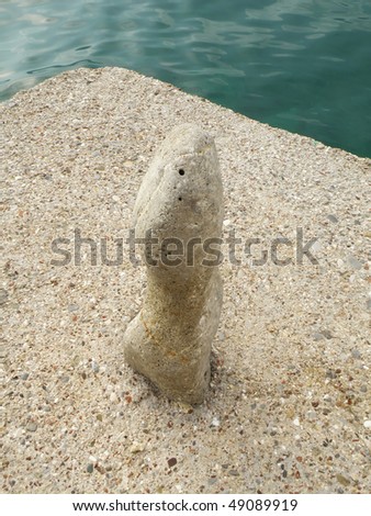 close up of mooring stone on a concrete pier