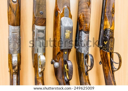 close up of a row of guns displayed in gun shop