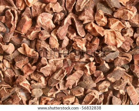 Raw cacao nibs; close-up; can be used as a background