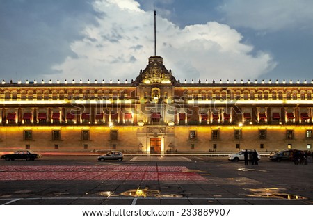 Illuminated National Palace in Plaza de la Constitucion of Mexico City at sunset. Zocalo and Army Square are among other local names of this place.
