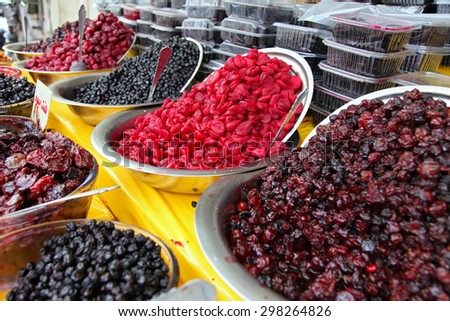 Traditionally dried and processed sour plums, sour cherries and forest fruits presented in large bowls to be sold in Darakeh and Darband recreational quarters of Tehran, Iran.