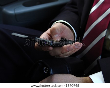 Businessman makes a call by cell phone in car