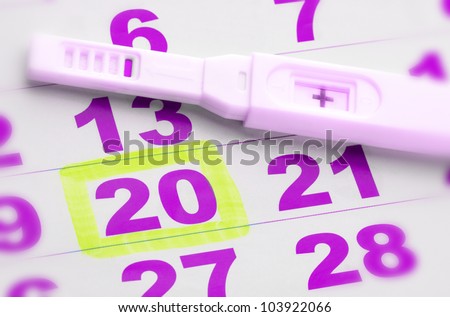 Positive pregnancy test on calendar page