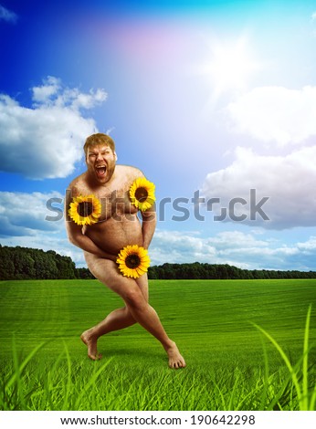 Nude man in  green field with sunflowers